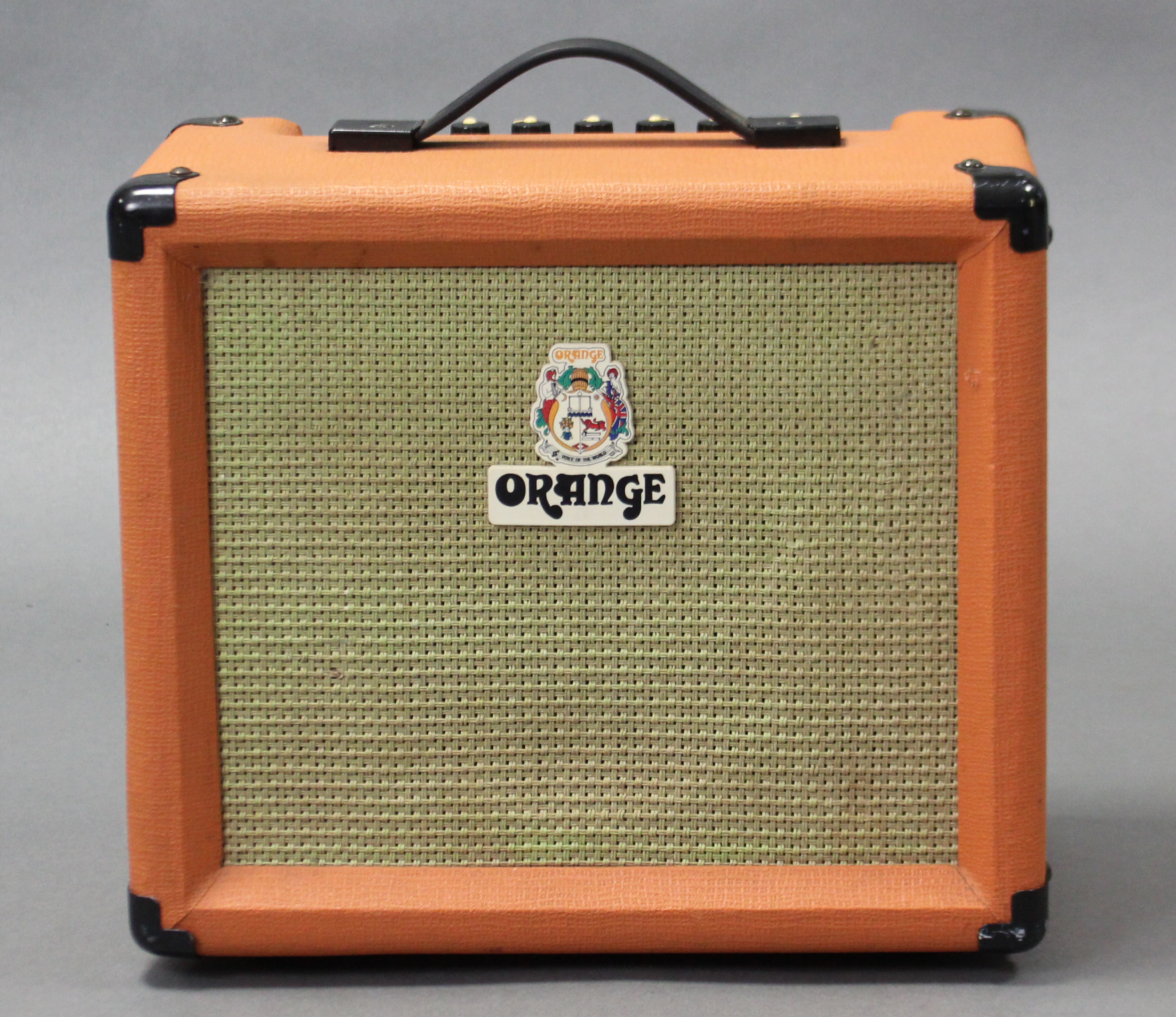 An orange “Crush 15” guitar amplifier.