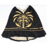 An early 20th century black satin ladies’ skirt with gold-thread embroidered geometrical decoration;
