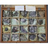 A collection of twenty various geological specimens, contained in a wooden box.