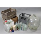 A Corona grey plastic twelve division crate; together with two wooden crates; a glass carboy; &