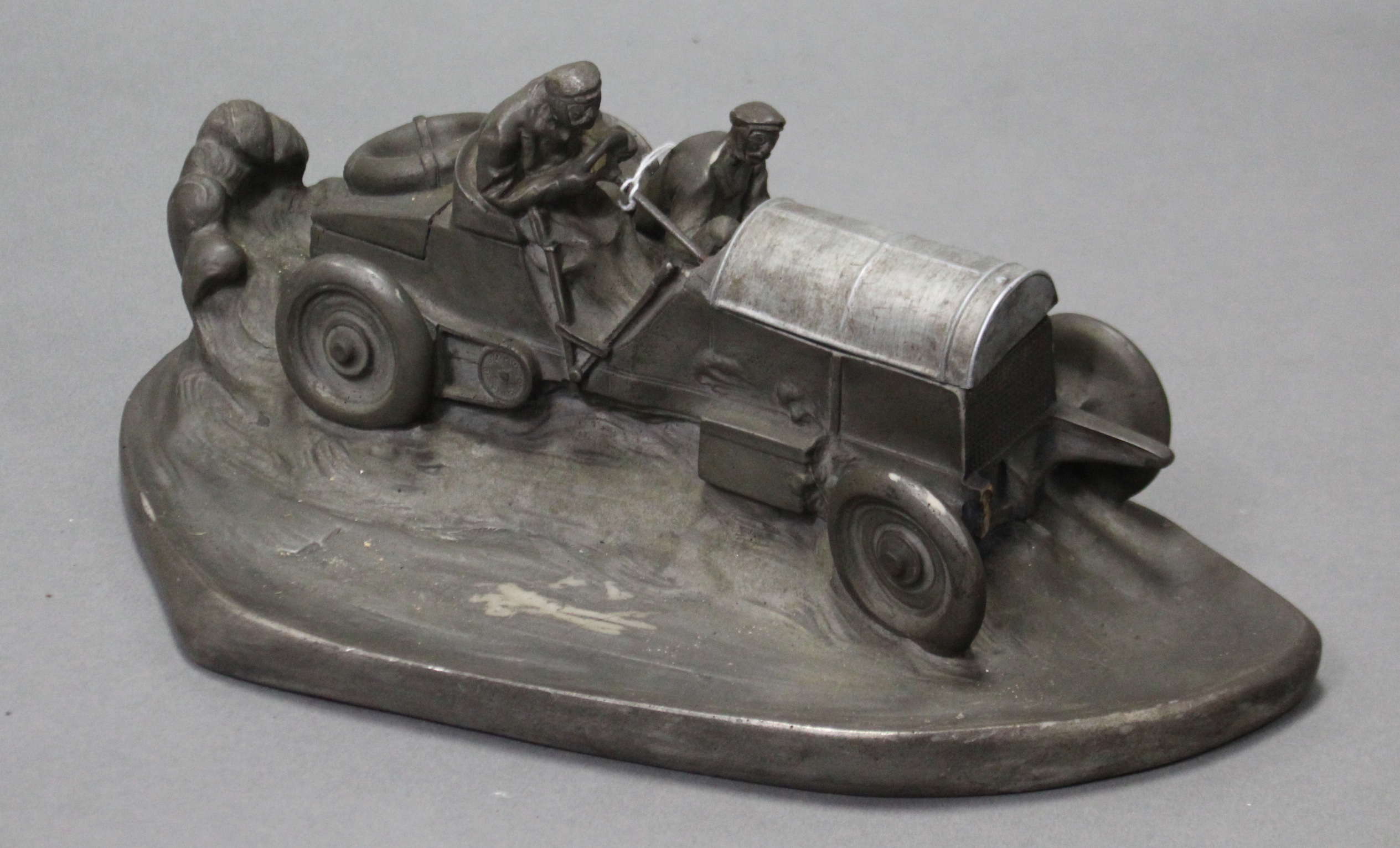A large pewter-finish composition novelty desk, inkstand in the form of a vintage motor car,