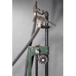 AN EARLY/MID 20th CENTURY GREEN & BLACK PAINTED CAST-IRON PETROL PUMP BY WAYNES of 42 NEWLANDS PARK,