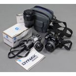 An Olympus “OM-10” 50mm camera; a Minolta Dynax 3000i” camera; & a Minolta “AF 70-210” zoom lens.