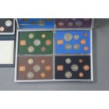 A collection of British proof coin sets, commemorative crowns, 10/- notes, etc.