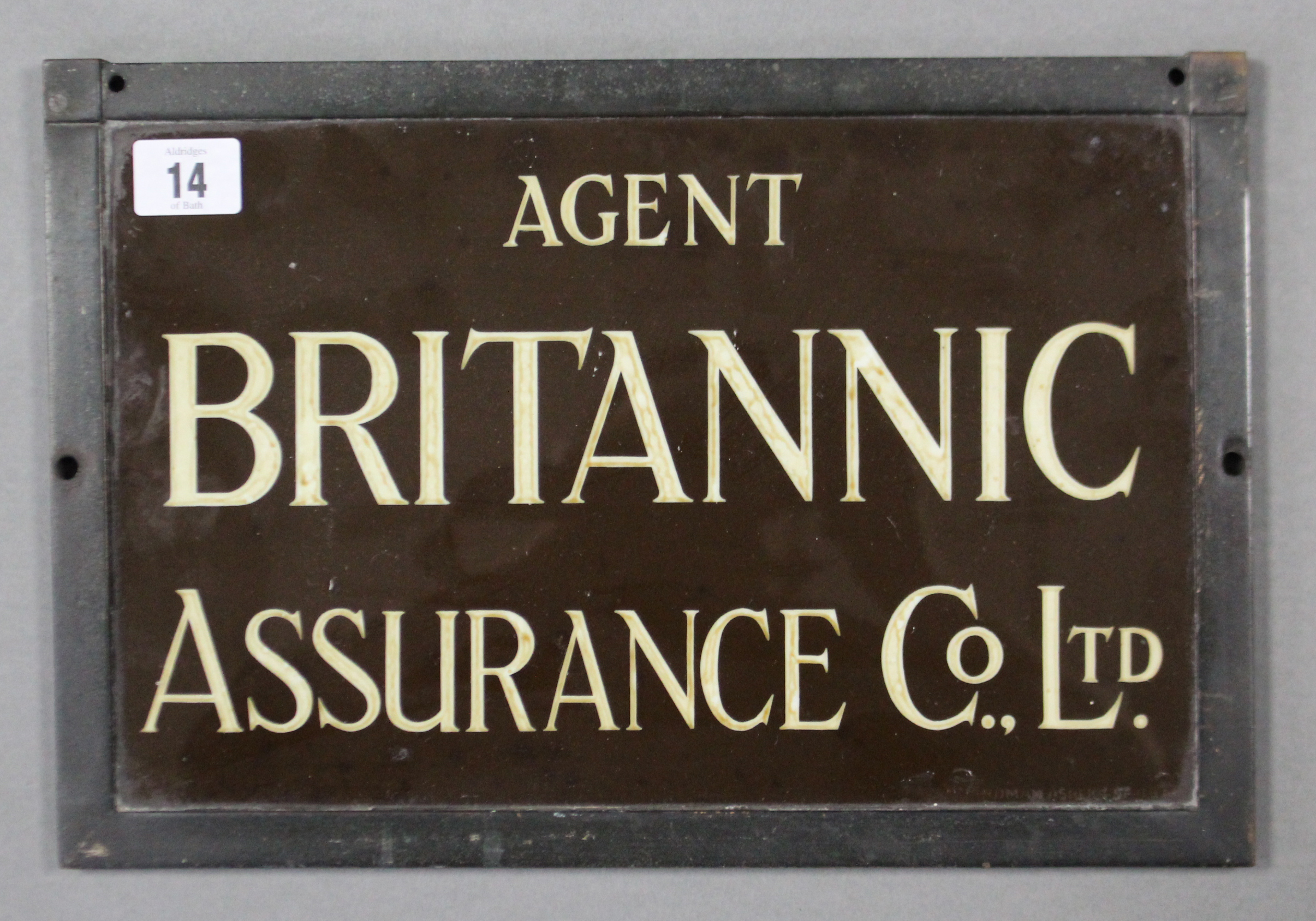 A brass rectangular plaque “AGENT BRITANNIC ASSURANCE CO LTD” 8” x 12½”, in glazed frame.