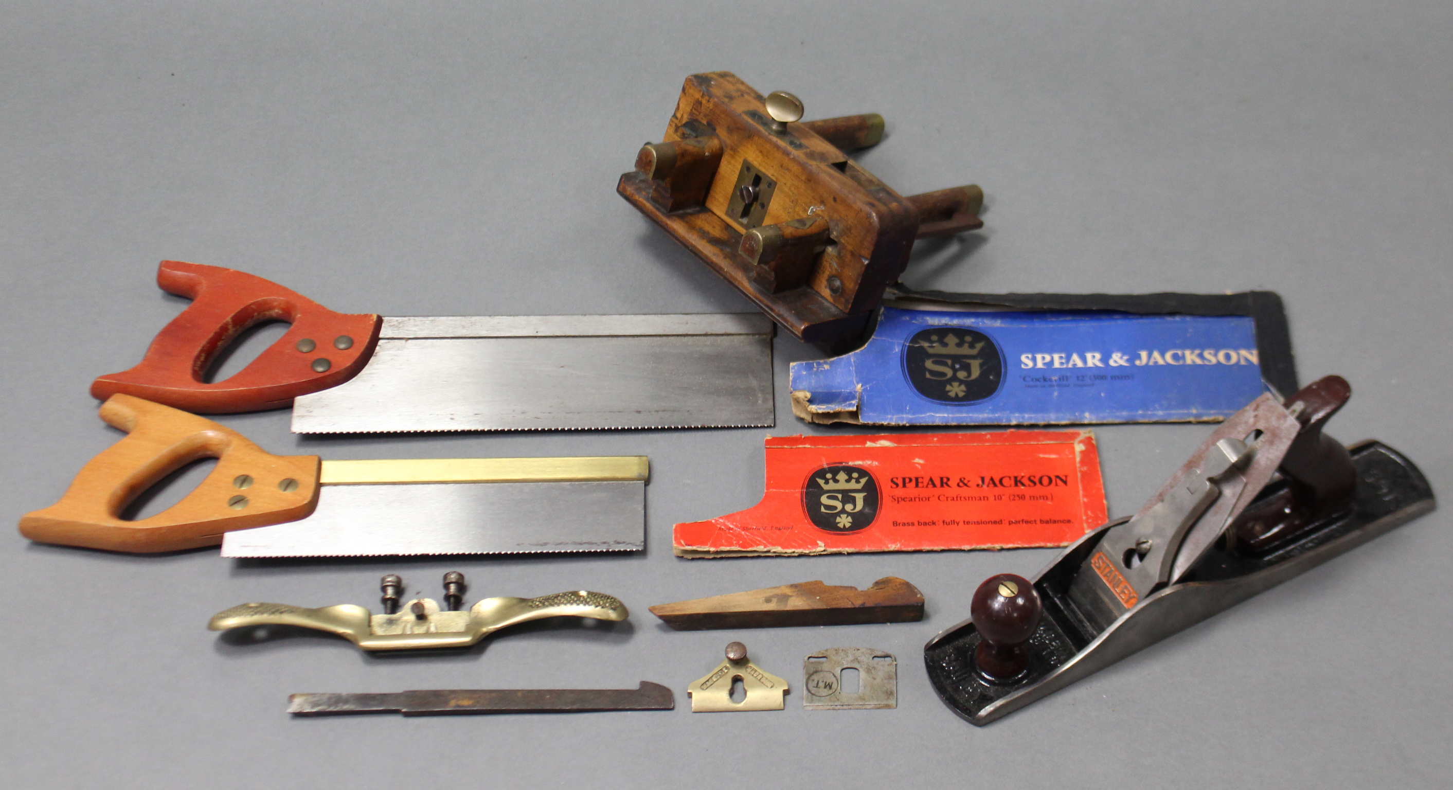 A Stanley Bailey “No. 5” smoothing plane; a treen moulding plane; two hand saws; & a spokeshave.