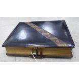 A late Victorian gilded and hide bound photograph album,