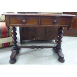 A mid Victorian mahogany writing table, the top with a moulded edge, over two frieze drawers,