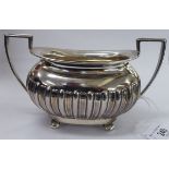 An Edwardian silver demi-reeded and fluted, oval twin handled sugar basin,