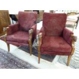 A pair of mid 20thC mahogany showwood framed chairs with level, square backs and enclosed arms,