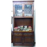 An Old Charm stained and carved oak display cabinet,