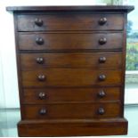 A late Victorian stained pine six drawer collector's chest, on a plinth 16.