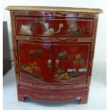 A modern lacquered red bow front cabinet with a drawer, over a pair of doors,