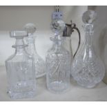 Four dissimilar cut crystal decanters with stoppers;