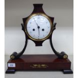A late 19thC Continental Empire style mahogany cased mantel clock with decoratively cast,