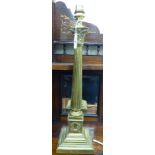 A modern brass table lamp with a Corinthian capital and a reeded column,