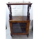 A late Victorian figures and fretworked walnut and satinwood marquetry music cabinet with a brass