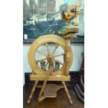 A mid 20thC pine spinning wheel and attachments/accessories CA