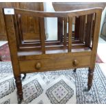 A late Victorian mahogany Canterbury with three divisions, on a box base drawer,