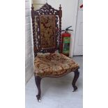 An Edwardian stained beech framed nursing chair,
