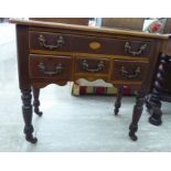 A late 19thC reproduction of a Georgian mahogany lowboy, comprising an arrangement of four drawers,