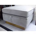 A modern grey coloured fabric upholstered, cushioned, square footstool,