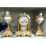 A late Victorian cast and gilt painted metal clock garniture,