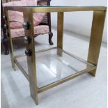 A Kelly Wearstler brass effect two tier lamp table with inset glazed panels and ball ornament,