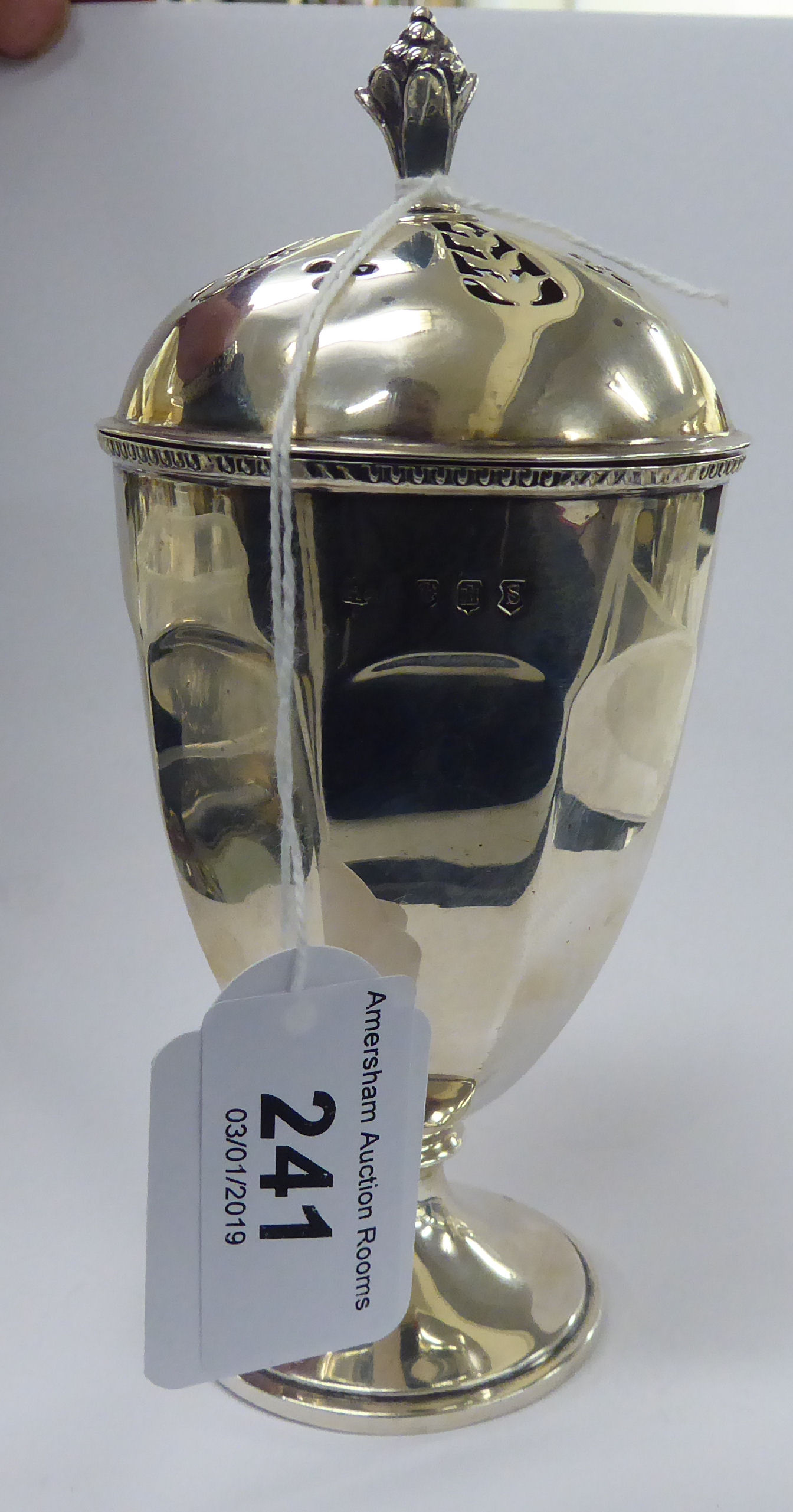 A Scottish silver pot pourri vase of panelled, pedestal cut design with a domed,