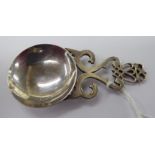 A Scottish silver caddy spoon, the round bowl on a decorative tab handle,