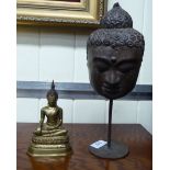 An Oriental cast metal Buddha 6''h; and a cast metal Buddha mask,