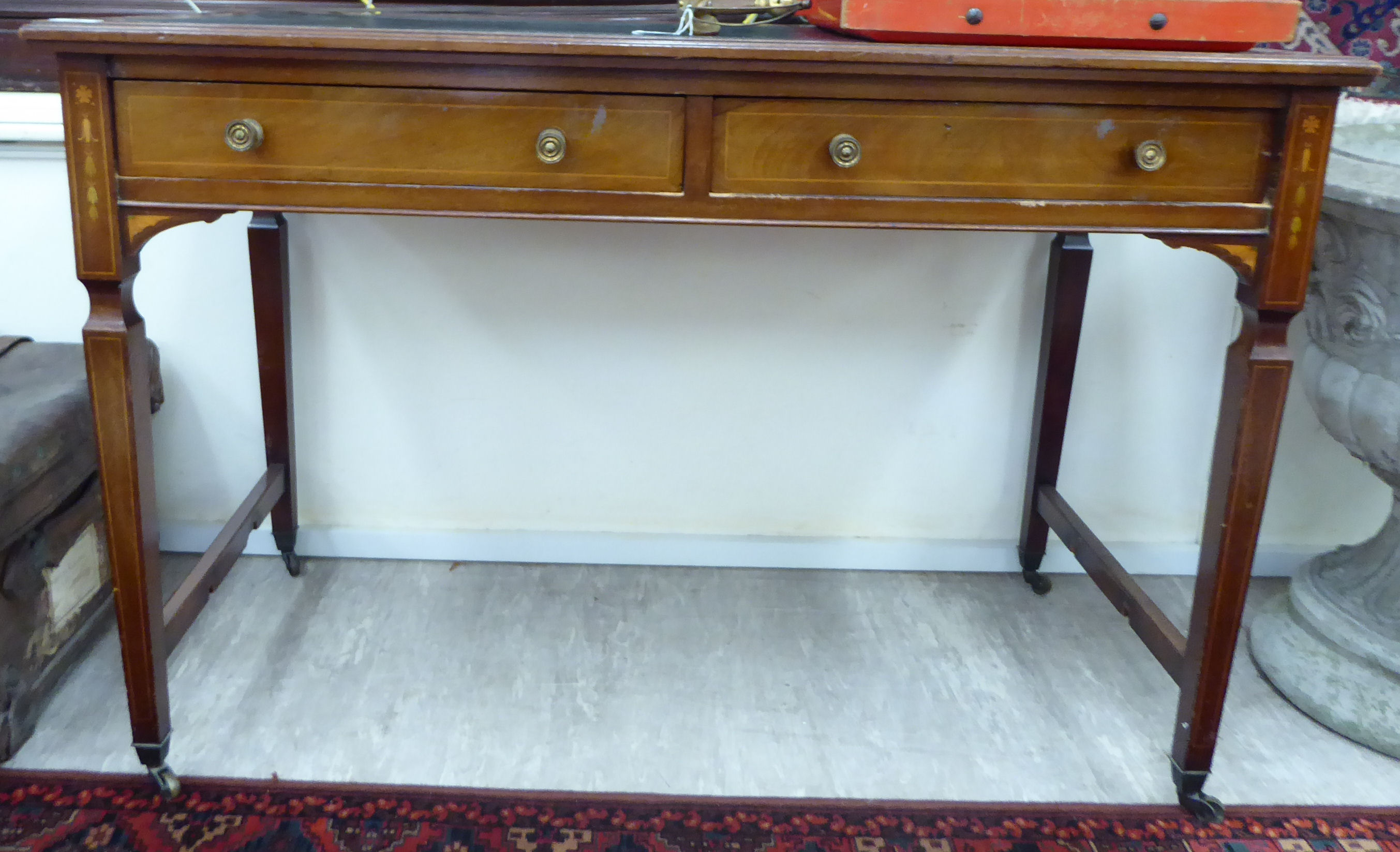 An Edwardian satinwood inlaid mahogany desk, the top set with a black hide scriber,