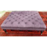 A modern Greengate stool, button upholstered in purple fabric,