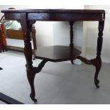 An early 20thC mahogany octagonal occasional table, raised on reeded, cabriole legs and casters,