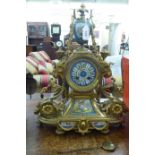 A late 19thC French elaborately cast gilt metal cased mantel clock with painted porcelain panels,