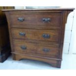 An early 20thC light oak dressing chest, having an overhanging top,