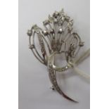 A white coloured gold ribbon tied and diamond set floral spray brooch stamped 750 11