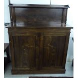 A mid Victorian rosewood chiffonier with a panelled upstand, over two panelled doors,