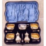 A matched set of late Victorian/Edwardian condiments comprising four salts,