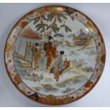 An early 20thC Kutani porcelain charger, traditionally decorated in colours and gilding,