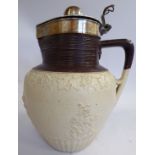 An early 19thC brown and cream coloured earthenware jug of shouldered, squat,