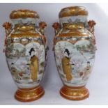 A pair of early 20thC Kutani porcelain baluster shaped vases, having cup shaped necks and moulded,