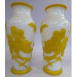 A pair of late 19thC Chinese opaque ivory coloured and yellow cameo glass vases of slender,