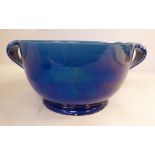 An early 20thC Japanese blue lustre glazed footed bowl with opposing strap handles 8''dia