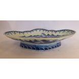 A late 18thC Chinese porcelain shallow, oval dish, having a lobed border, on a deep footrim,