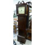 A late 18thC oak longcase clock with a swan neck pediment and a waisted trunk,