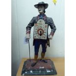 A late Victorian painted spelter clock, fashioned as a man in period costume,