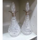 A pair of early 20thC cut-glass decanters with silver collars Sheffield 1927 with stoppers and