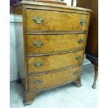 A mid 20thC figured walnut, bow front chest, the five graduated drawers with iron bail handles,