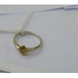 An 18ct bi-coloured gold ring, set with a single diamond,